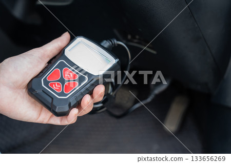 Woman using OBD2 diagnostic scanner.  133656269