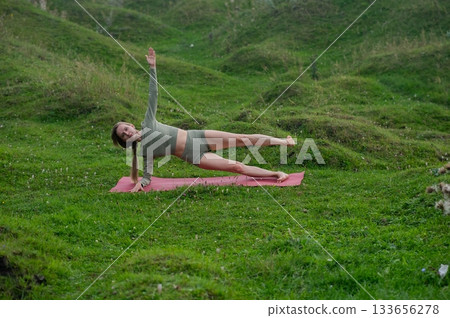 Caucasian woman doing yoga outdoors. Caucasian woman doing yoga outdoors. 133656278