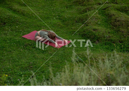 Caucasian woman doing yoga outdoors. Caucasian woman doing yoga outdoors. 133656279