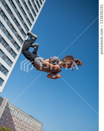 A girl jumps on a gymnastic trampoline. 133656281
