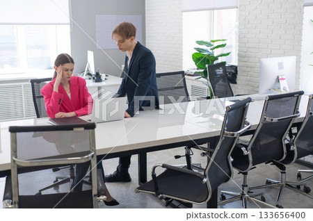 Caucasian man giving instructions to subordinate. Caucasian man giving instructions to subordinate. 133656400