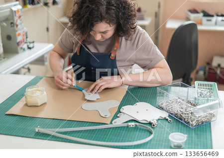 Woman tanner at work in the workshop.  133656469