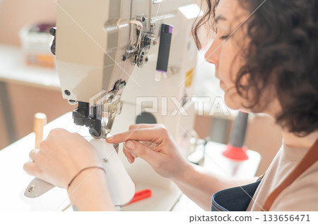 Woman tanner at work in the workshop. Woman tanner at work in the workshop. 133656471