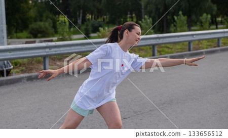 Caucasian woman rollerblading fast on road. Caucasian woman rollerblading fast on road. 133656512
