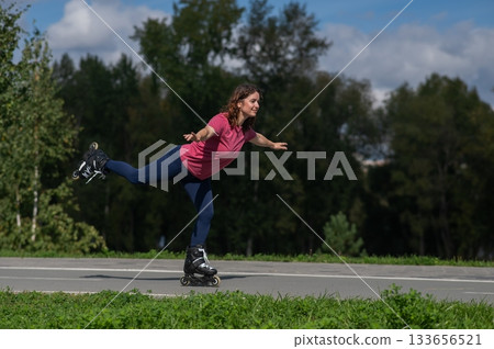 Caucasian woman roller skating in park.  133656521