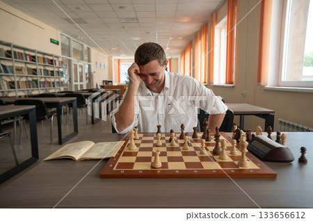 Middle aged Caucasian man playing chess. Middle aged Caucasian man playing chess. 133656612