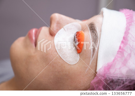Caucasian woman undergoing eyelash lamination procedure.  133656777