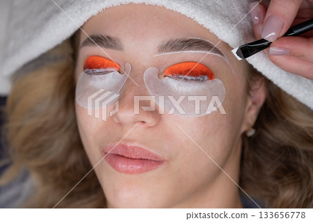 The process of professional lamination and dyeing of eyelashes and eyebrows in the salon.  133656778