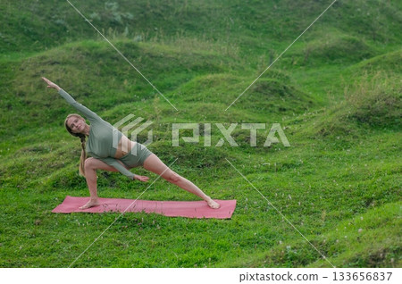 Caucasian woman doing yoga outdoors.  133656837