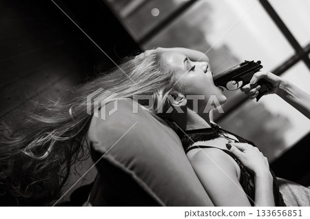 A Caucasian woman lies with a gun in her mouth. Role-playing games. 133656851