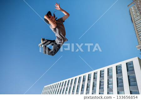 A girl jumps on a gymnastic trampoline. 133656854