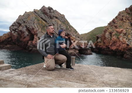 Father and son bonding exploring rocky coast travel Father and son bonding exploring rocky coast travel 133656929