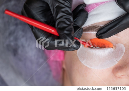 Caucasian woman undergoing eyelash lamination procedure.  133657103