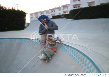 Father and son enjoying a day at the skatepark Father and son enjoying a day at the skatepark 133657104