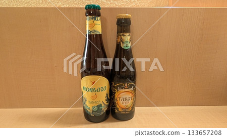 Banana beer and fruit beer bottles on the table Banana beer and fruit beer bottles on the table 133657208