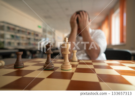 Middle aged Caucasian man playing chess. Middle aged Caucasian man playing chess. 133657313