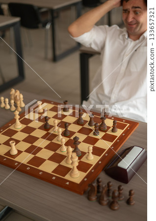 Middle aged Caucasian man playing chess. Middle aged Caucasian man playing chess. 133657321