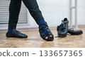 A man dancing Irish dances. Professional shoes are in the foreground. 133657365