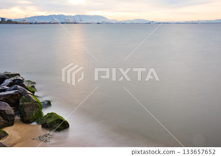 Quiet morning beach | Long exposure, soft water surface Quiet morning beach | Long exposure, soft water surface 133657652
