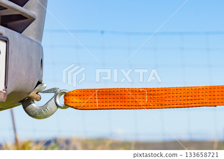 Tow hook with orange strap on car. Towing equipment. Tow hook with orange strap on car. Towing equipment. 133658721