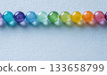 Vivid background banner material with rainbow colored beads arranged in a horizontal row 133658799