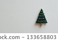 Miniature illustration of a Christmas tree decorated with gold beads 133658803