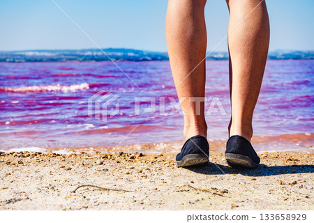 Woman on pink lake in Spain Woman on pink lake in Spain 133658929