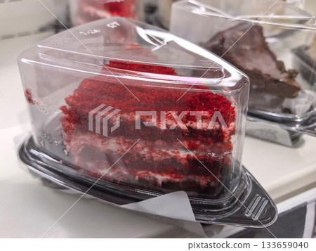 Rich red velvet cake displayed in a plastic container at a dessert shop 133659040