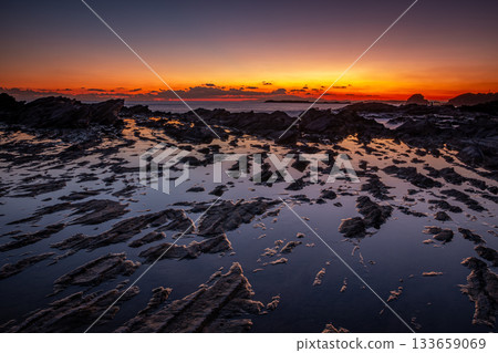 A vibrant sunset and tide pools reflected on the reefs of Takaiso in Misakicho, Miura City 133659069
