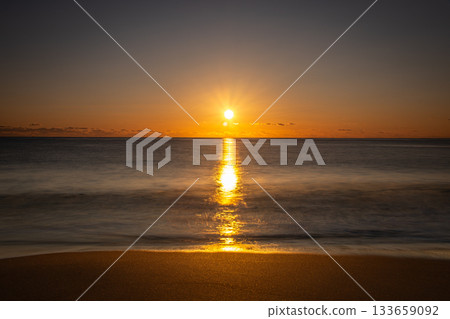 河原鄉海岸的冬日日出，一道金色的光帶橫跨海面（茨城縣） 133659092