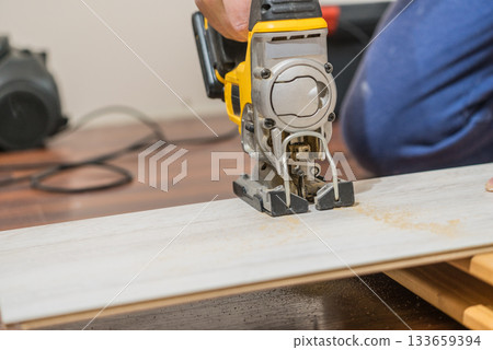 Person cutting floor panels 133659394