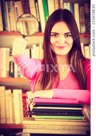 Funny girl holding magnifying glass Funny girl holding magnifying glass 133659630