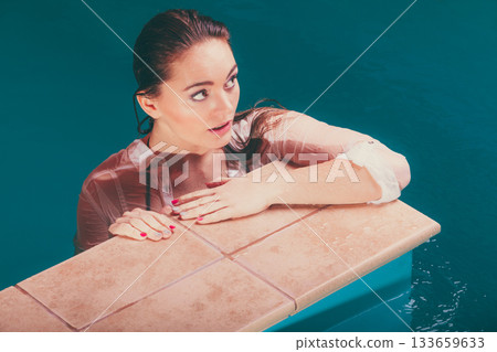 Portrait of sexy seductive woman at poolside water Portrait of sexy seductive woman at poolside water 133659633