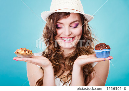 Smiling summer woman holds cakes in hand Smiling summer woman holds cakes in hand 133659648