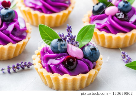 Delicious and colorful dessert cups filled with purple cream and topped with berries and lavender flowers created for a spring celebration 133659862