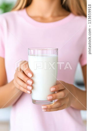 Smiling young woman enjoying fresh milk in a cheerful kitchen showcasing a healthy lifestyle Smiling young woman enjoying fresh milk in a cheerful kitchen showcasing a healthy lifestyle 133659918