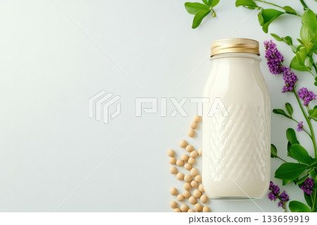 Creamy soy milk in glass bottle surrounded by raw soybeans and fresh herbs showcases a plant-based diet concept Creamy soy milk in glass bottle surrounded by raw soybeans and fresh herbs showcases a plant-based diet concept 133659919