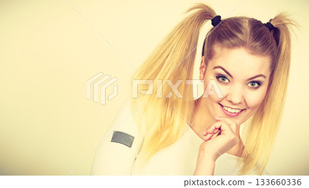 Happy blonde teenager girl with ponytails Happy blonde teenager girl with ponytails 133660336