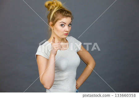 Woman wearing eyeglasses pointing at camera Woman wearing eyeglasses pointing at camera 133660358