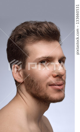 Man smiling slightly with nose bandage during early recovery Man smiling slightly with nose bandage during early recovery 133660531