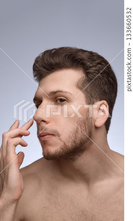 Man examining nose bandage from side profile after procedure Man examining nose bandage from side profile after procedure 133660532