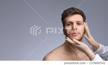 Doctor assessing male face before aesthetic injection procedure Doctor assessing male face before aesthetic injection procedure 133660542