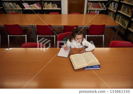 Young Student Studying in Library During Book Day at Public School Library 133661330