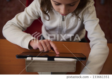 Child Using Tablet In Library For Learning And Education Focused On Knowledge At School Child Using Tablet In Library For Learning And Education Focused On Knowledge At School 133661351