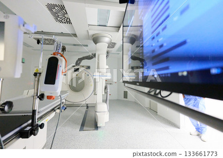 Modern medical imaging room equipped with advanced diagnostic machines and a computer screen in a healthcare facility 133661773