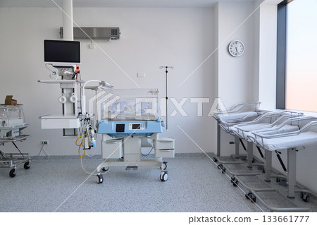 Newborn care unit equipped with incubators and cribs in a hospital setting during daylight hours Newborn care unit equipped with incubators and cribs in a hospital setting during daylight hours 133661777