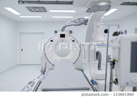 Modern medical imaging room equipped with advanced CT scanner ready for patient examination and diagnostics Modern medical imaging room equipped with advanced CT scanner ready for patient examination and diagnostics 133661960