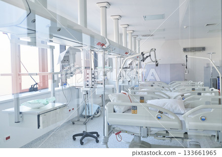 Modern hospital room with equipped beds and bright natural light during daytime hours Modern hospital room with equipped beds and bright natural light during daytime hours 133661965