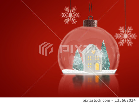 A glass snow globe with a small white house and two green Christmas trees inside. 133662024