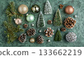 A green background with a variety of Christmas decorations including pine cones 133662219